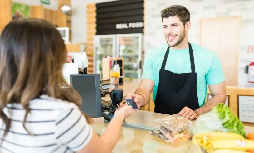 smiling-male-cashier-receiving-payment-through-credit-card-supermarket_p36207_cover_image_resized